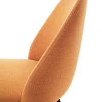 Stylish orange upholstered chair with a soft texture and sleek silhouette, perfect for modern decor.