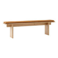 Light wood bench with a warm brown cushion, showcasing a minimalist design and natural grain patterns.
