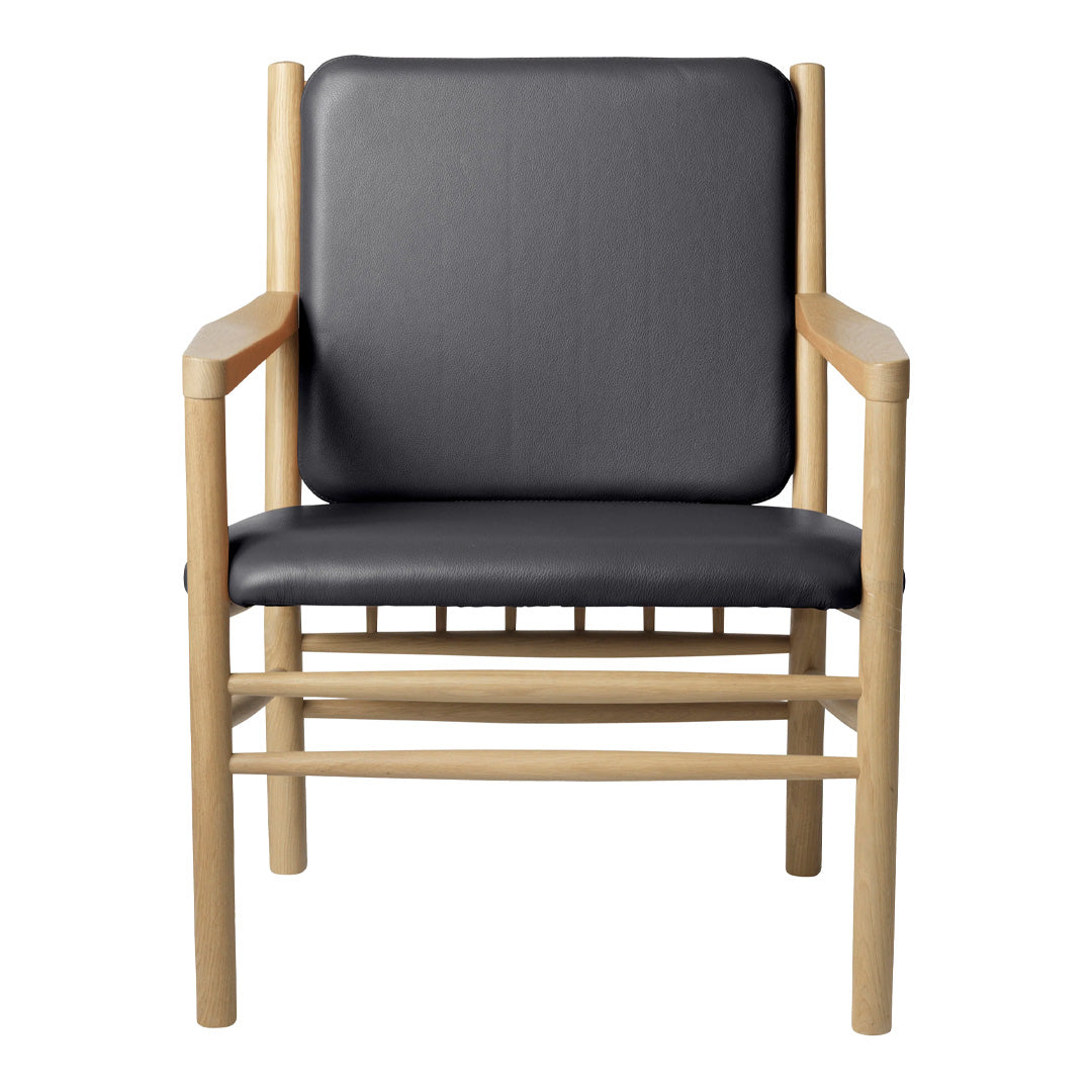 Black leather armchair with natural wood frame, featuring a sleek, minimalist design and no intricate patterns.