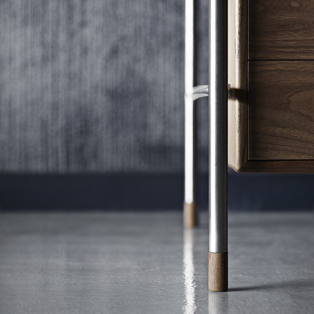 Close-up of a sleek wooden drawer with metal legs featuring a natural wood finish and a muted gray background.