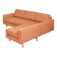 Orange fabric sectional sofa with tufted cushions and wooden legs, featuring a modern and minimalist design.