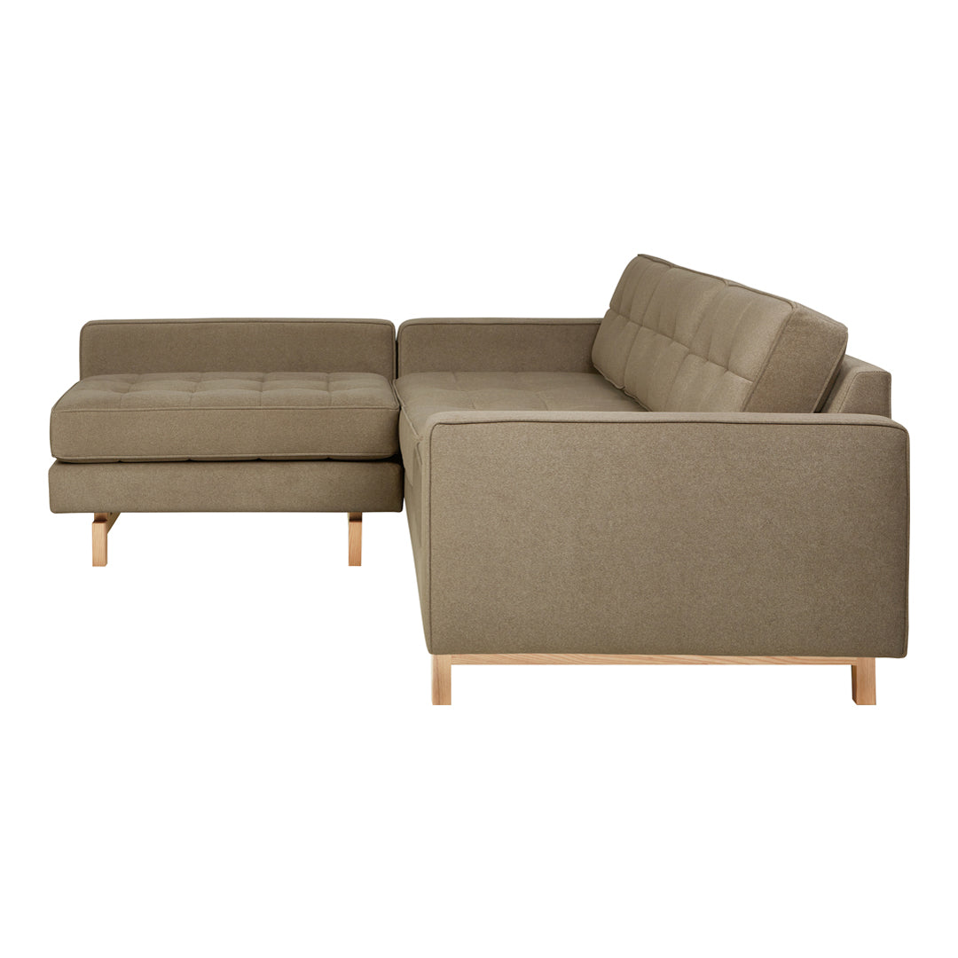 Light olive green sectional sofa with a smooth fabric texture and natural wood legs. Contemporary design for modern decor.