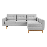 Gray tufted sectional sofa with a clean design and light wood legs, perfect for modern living spaces.