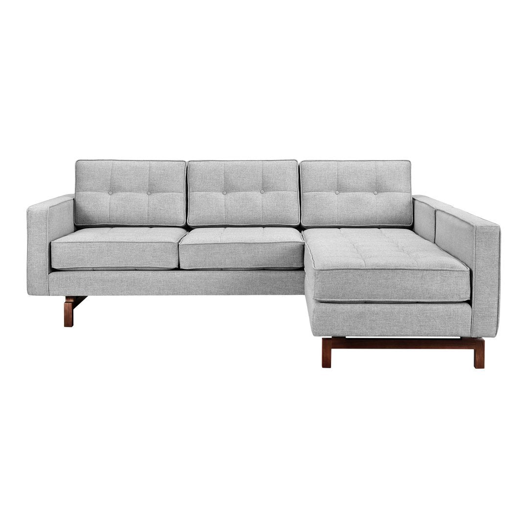Light gray tufted sectional sofa with a sleek design and rich brown wood legs. Perfect for modern living spaces.