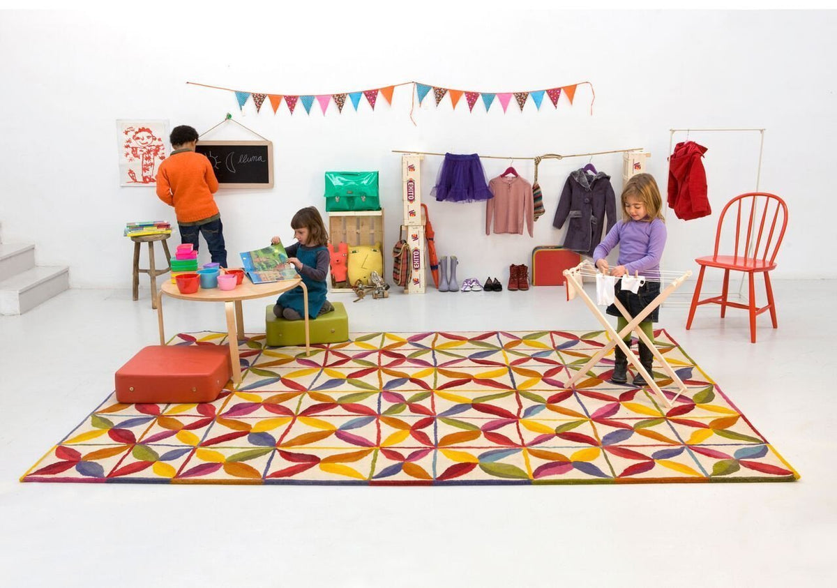 Colorful geometric rug featuring red, yellow, blue, and green patterns, perfect for kids' play areas.