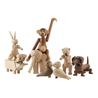 Wooden animal figurines in natural tones and textures, showcasing a mix of light and dark wood patterns.