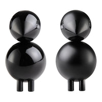 "Pair of glossy black abstract figurines featuring smooth and rounded shapes with contrasting matte legs."