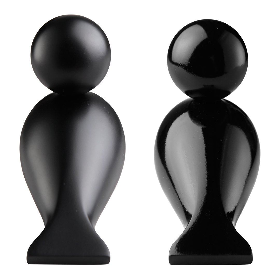 Black ceramic decorative figurines with smooth, glossy finishes and rounded shapes, showcasing modern design.