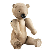 Natural wooden bear toy in light oak with a smooth, grainy texture. Simple design with a neutral color palette.