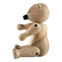 Natural wood bear figurine with smooth beige finish and black accent features. Simple and charming design.