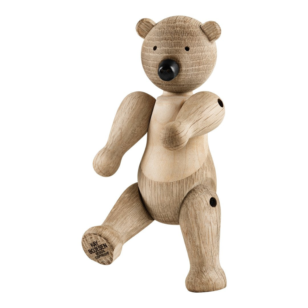 Wooden bear figurine in natural wood tones with smooth, rounded features and subtle grain pattern. Perfect for decor.
