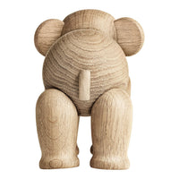 Natural wood elephant figurine with a smooth, textured finish in light oak color and subtle grain pattern.