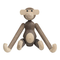 Wooden monkey figure featuring a mix of natural brown and light beige tones with smooth, rounded shapes.