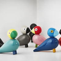 Colorful ceramic bird figurines in vibrant yellow, red, blue, grey, and pink with playful patterns. Ideal for home decor.