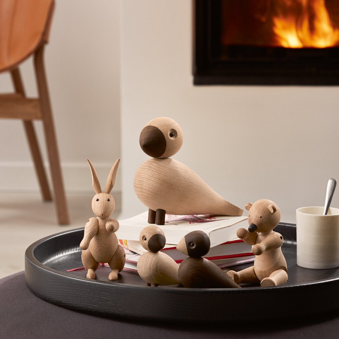 Wooden animal figurines in natural tones with smooth finishes, showcasing minimalist design and soft color variations.