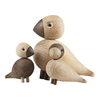 Set of three wooden bird figurines showcasing natural tones of light and dark wood, featuring smooth, rounded shapes.