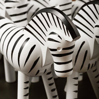 Black and white striped decorative zebras with glossy finish, perfect for home decor or gifting.