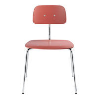 Coral pink chair with a smooth surface and minimalist design, featuring two round backrest holes and chrome legs.