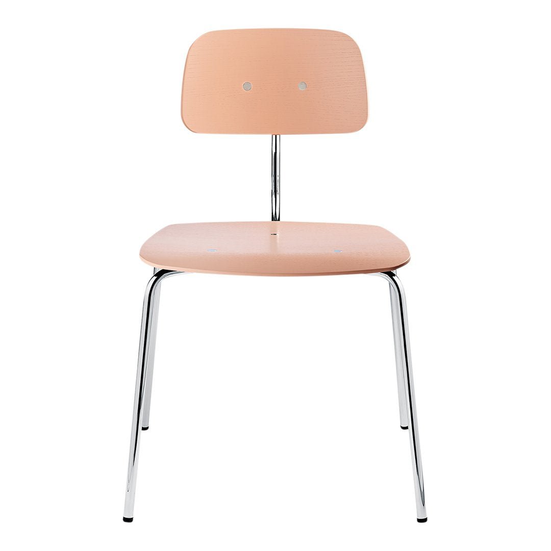 Peach-colored chair with a smooth, minimalist design and sleek chrome legs. Ideal for modern decor.