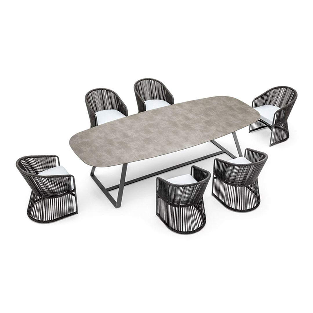 Stylish outdoor dining set featuring a grey patterned table and black woven chairs with white cushions.