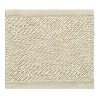 Stylish cream-colored textured mat with a subtle diamond pattern and beige trim. Perfect for any decor.