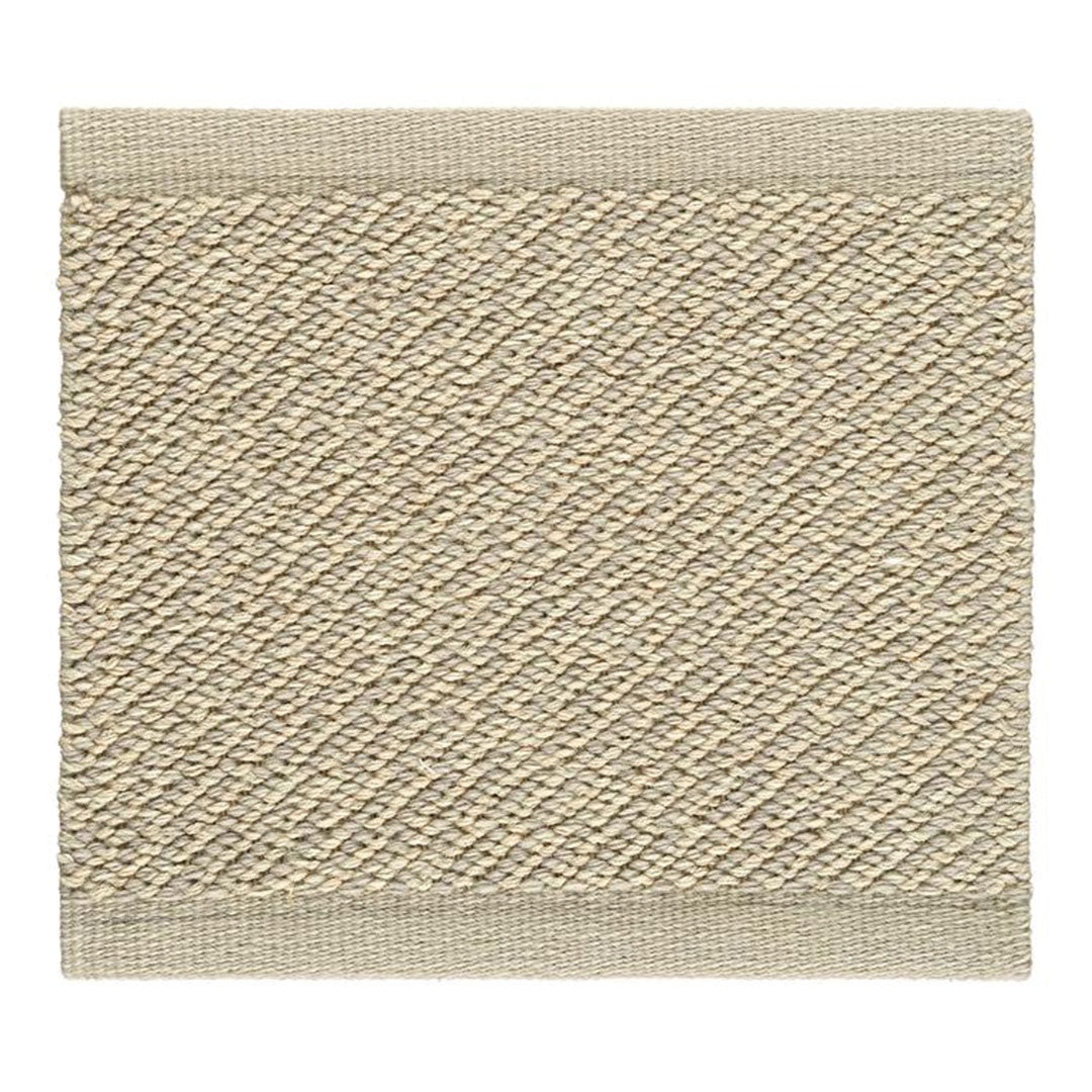 Beige textured mat with a diamond pattern and a solid border. Perfect for adding a neutral touch to any space.