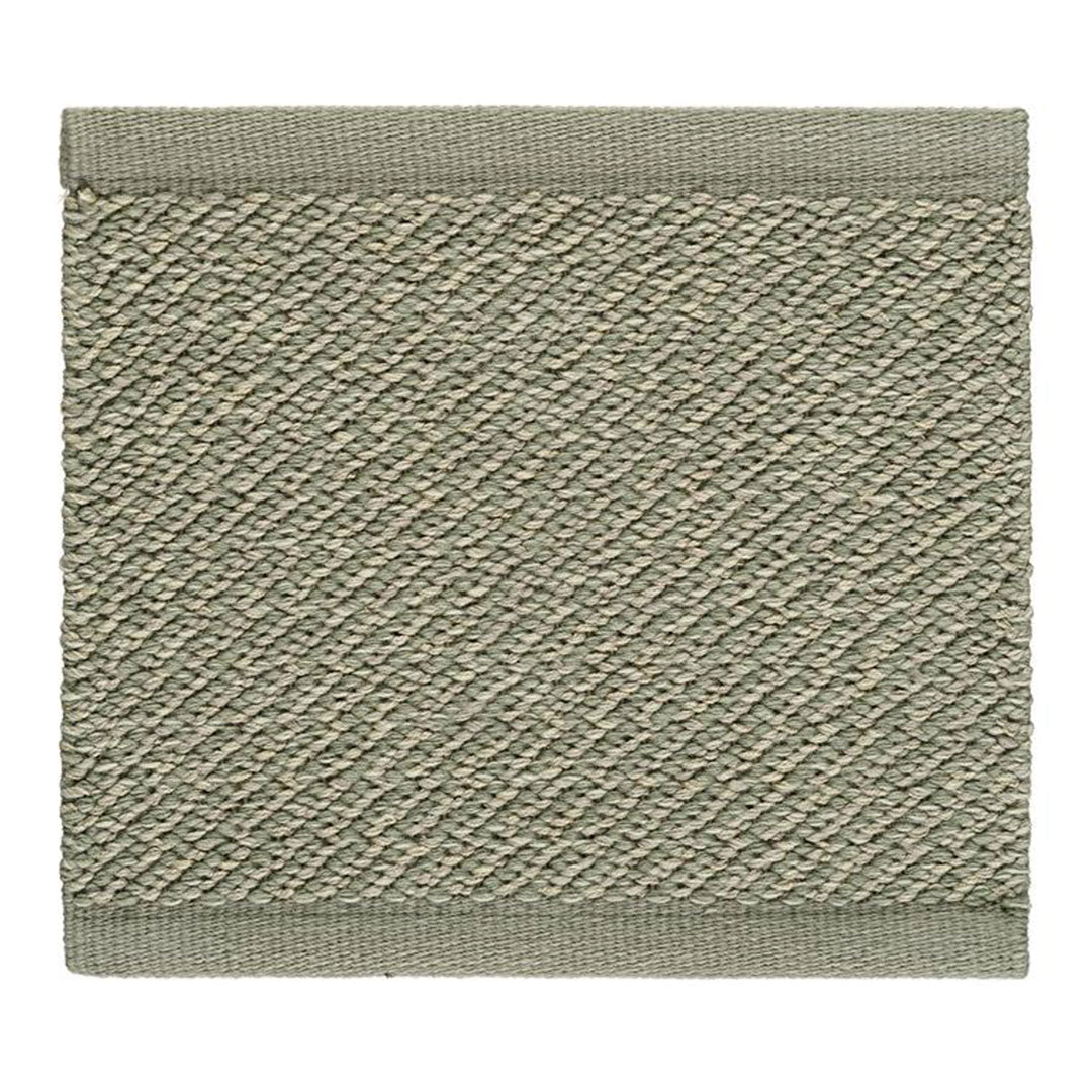 Textured rectangular mat in muted green with a subtle diagonal pattern and contrasting border.