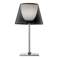 Stylish black and white lamp with a sleek chrome base and patterned shade, perfect for modern decor.