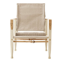 Light beige fabric with a simple, woven texture on a minimalist wooden chair frame in pale natural tones.