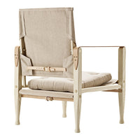 Light beige upholstered chair with a minimalist design and smooth, cream-colored wooden frame.