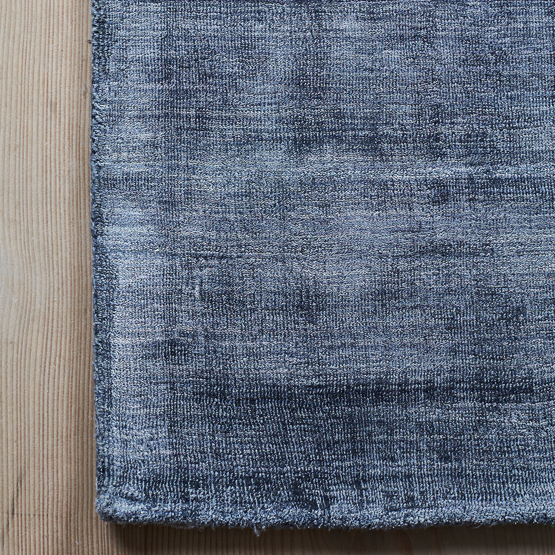 Gray textured fabric with subtle mottled patterns, ideal for modern home decor.