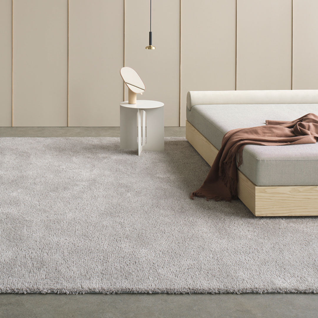 Soft gray shag rug with a subtle texture, complementing minimalist decor. Perfect for modern interiors.