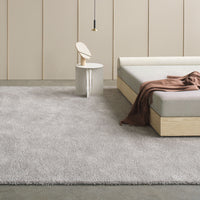 Soft gray shag rug with a subtle texture, complementing minimalist decor. Perfect for modern interiors.