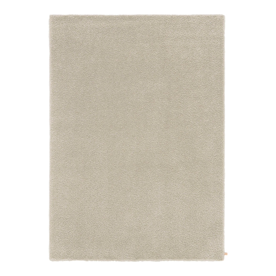 Light beige area rug with a soft, solid texture, perfect for modern decor. 