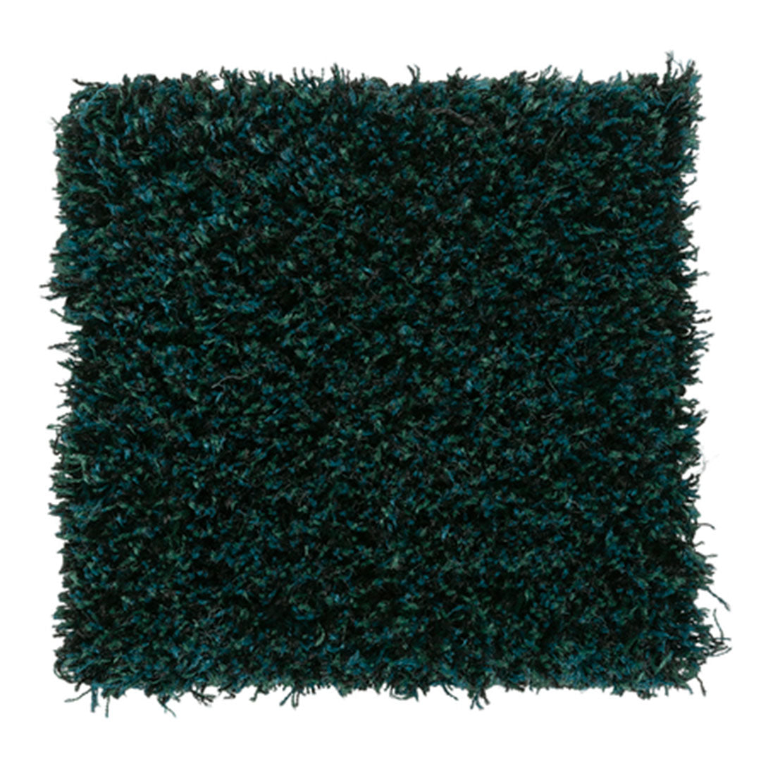 Teal green shag rug with a plush, textured pattern, perfect for adding depth and warmth to any space.