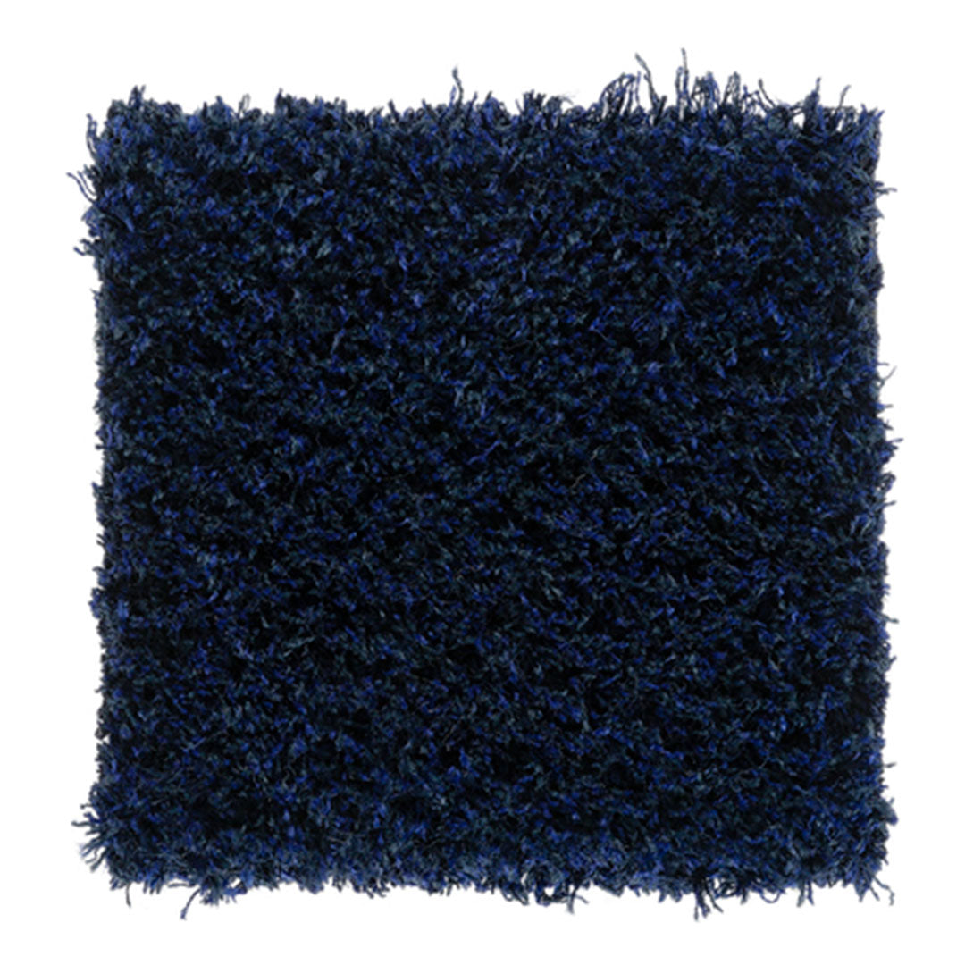 Soft navy shag rug with textured, fluffy fibers in deep blue hues. Ideal for adding warmth to any space.