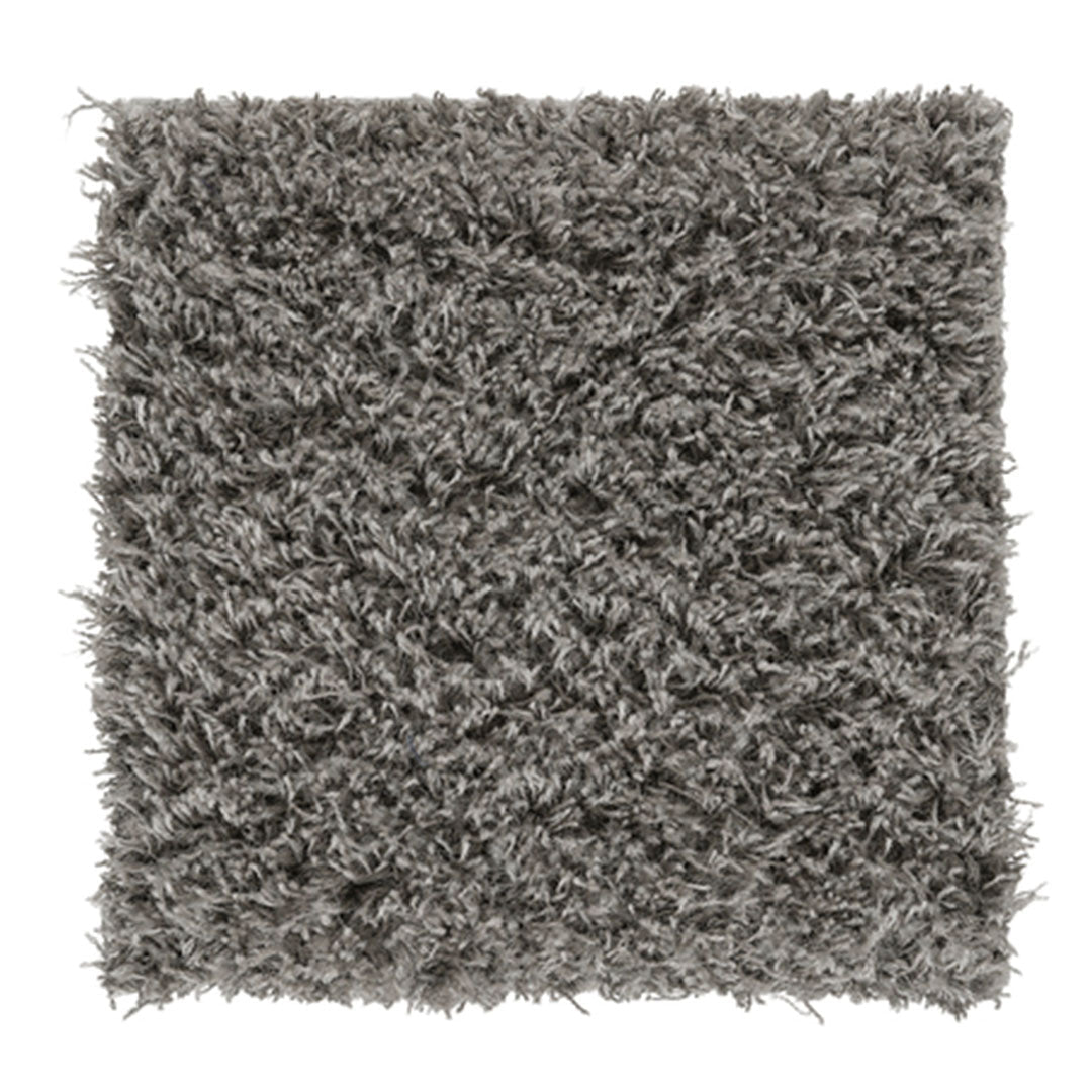Soft shaggy rug in a textured gray color, adding warmth and depth to any room design.