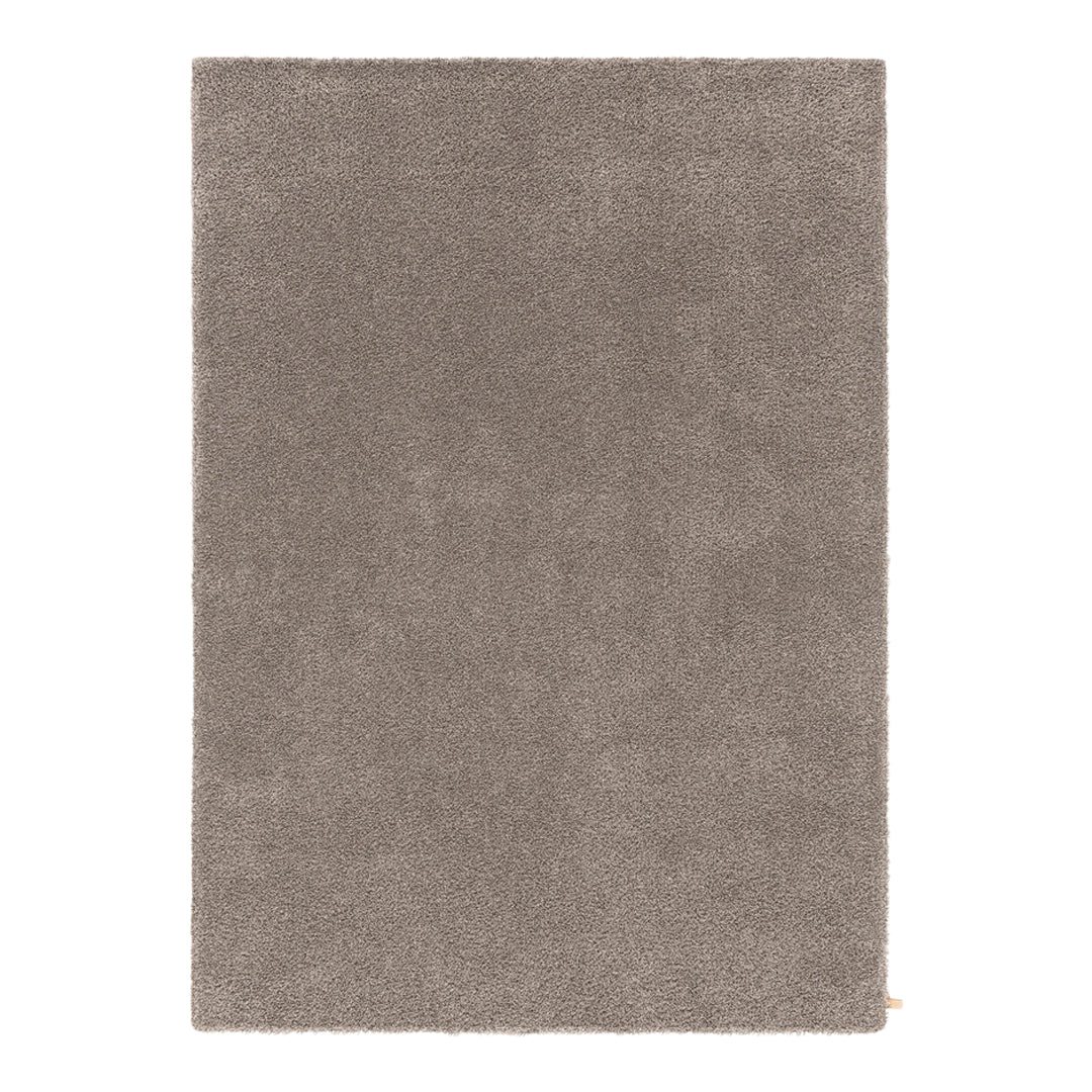 Soft taupe rug with a plush texture and solid color design, perfect for enhancing any living space.
