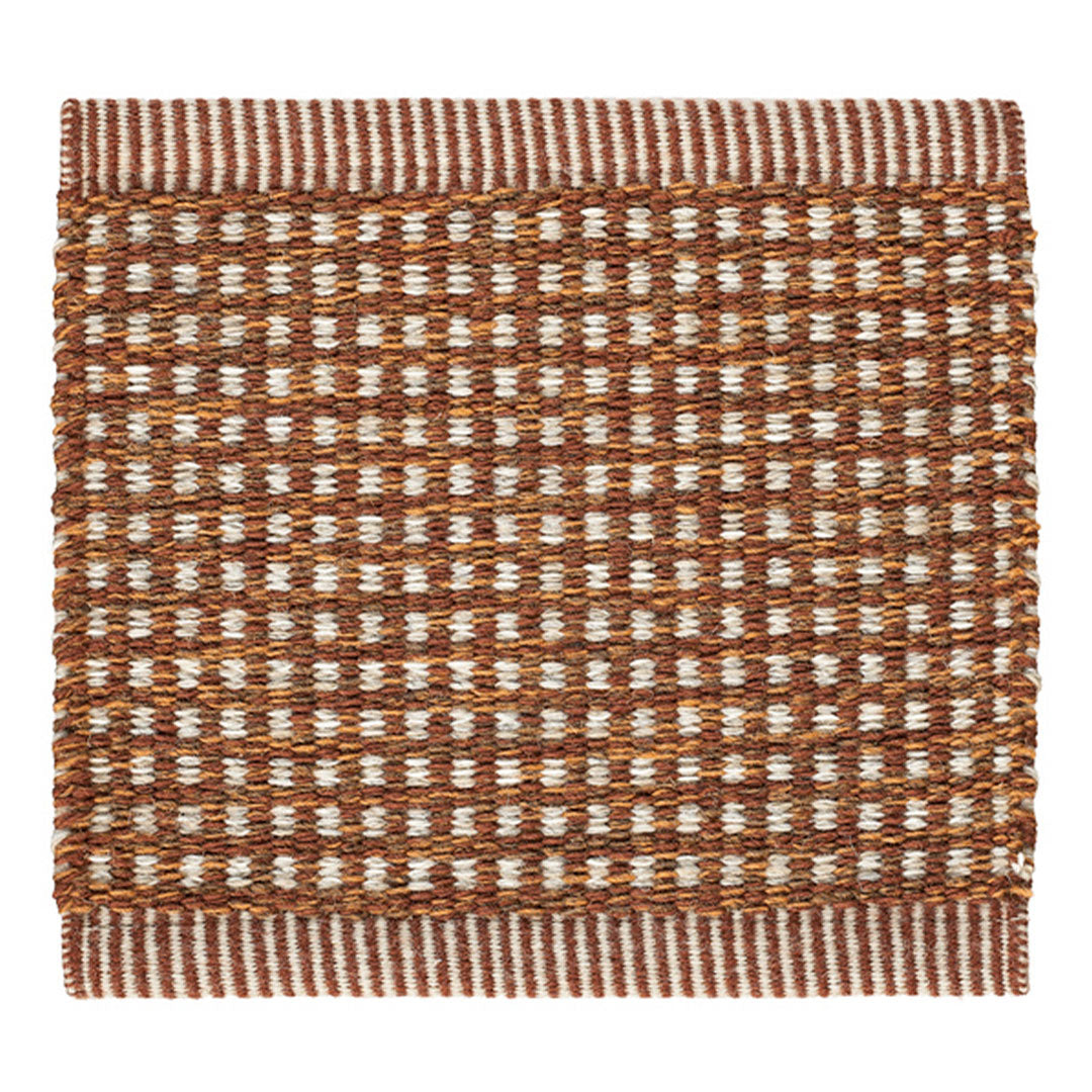 Brown and cream woven rug with a textured checkered pattern and fringed edges. Perfect for adding warmth to any space.