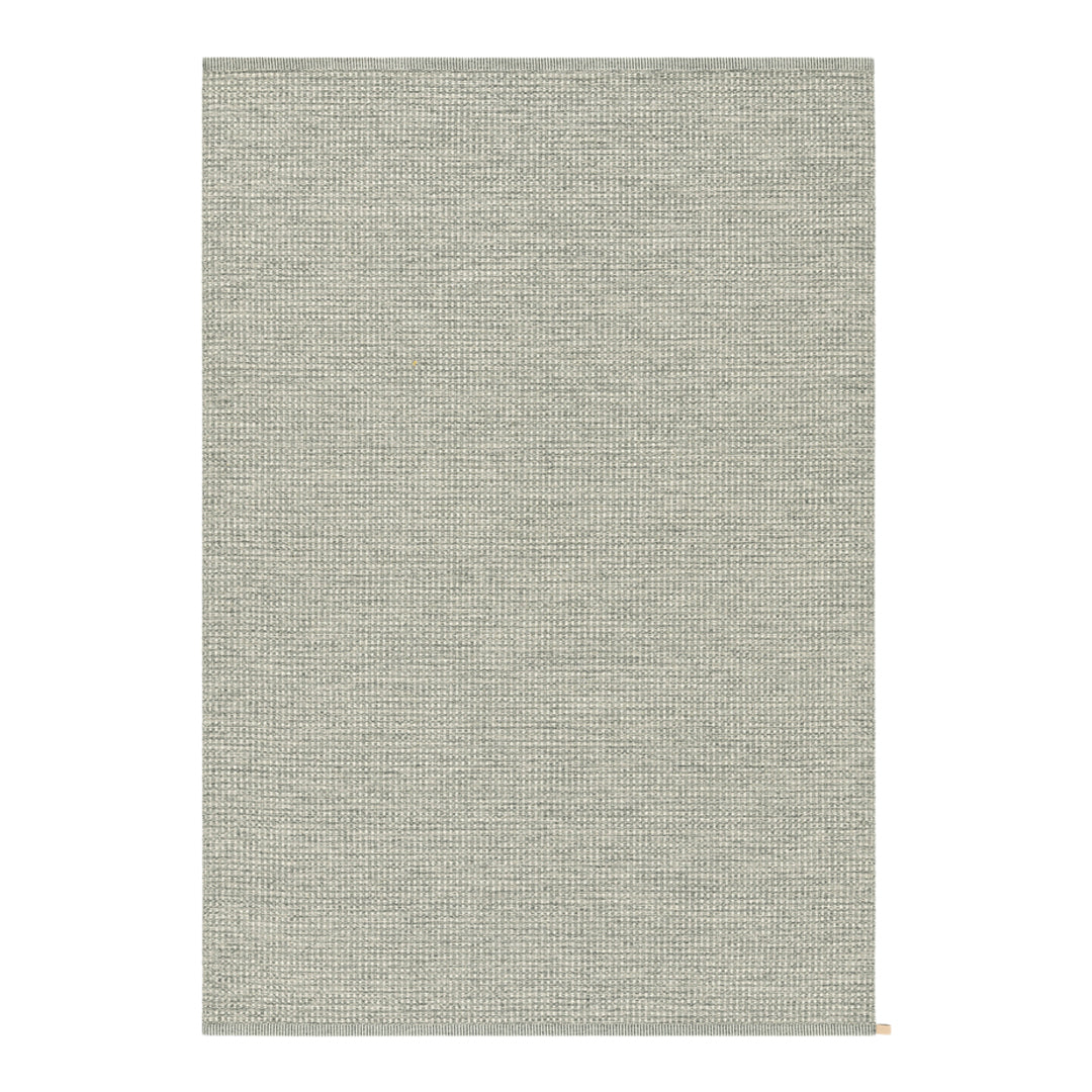 Light gray textured area rug featuring subtle, minimalist pattern for modern decor. Perfect for any room.