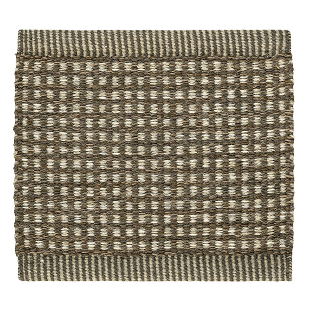 Brown and cream woven rug with a striped border, featuring a textured checkered pattern. Perfect for cozy decor.