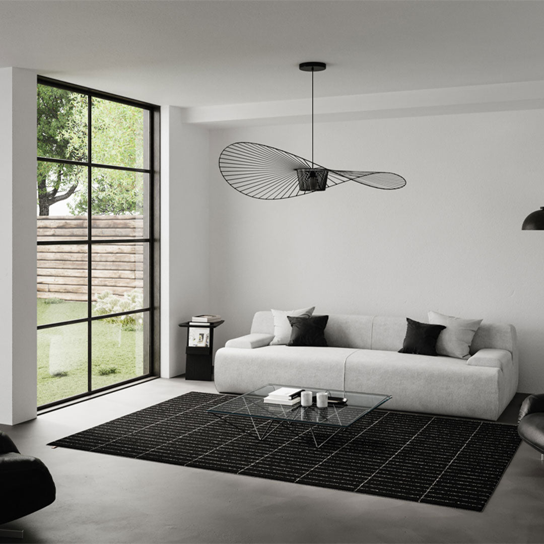 Modern living room featuring a monochromatic palette with black and white elements, geometric patterns, and sleek lines.