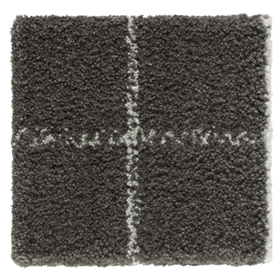 Gray shag rug with white stitched pattern, featuring a textured surface and geometric design. Perfect for adding warmth.