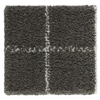 Gray shag rug with white stitched pattern, featuring a textured surface and geometric design. Perfect for adding warmth.