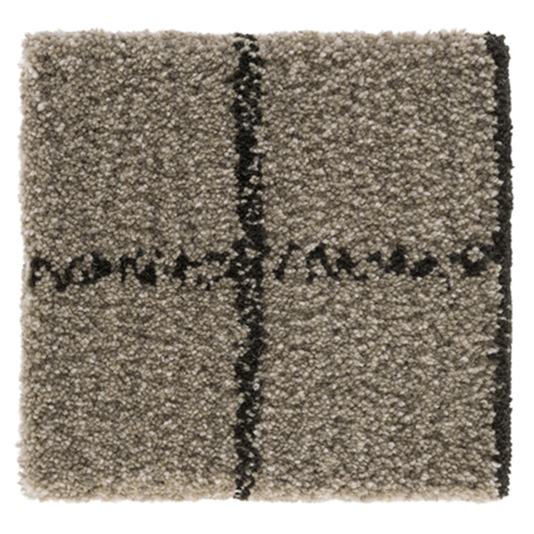 Textured beige and gray shag rug with bold black lines and a modern cross pattern. Perfect for adding warmth and style.