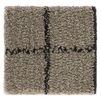 Textured, beige rug with black geometric pattern and soft, shaggy finish. Perfect for modern decor.