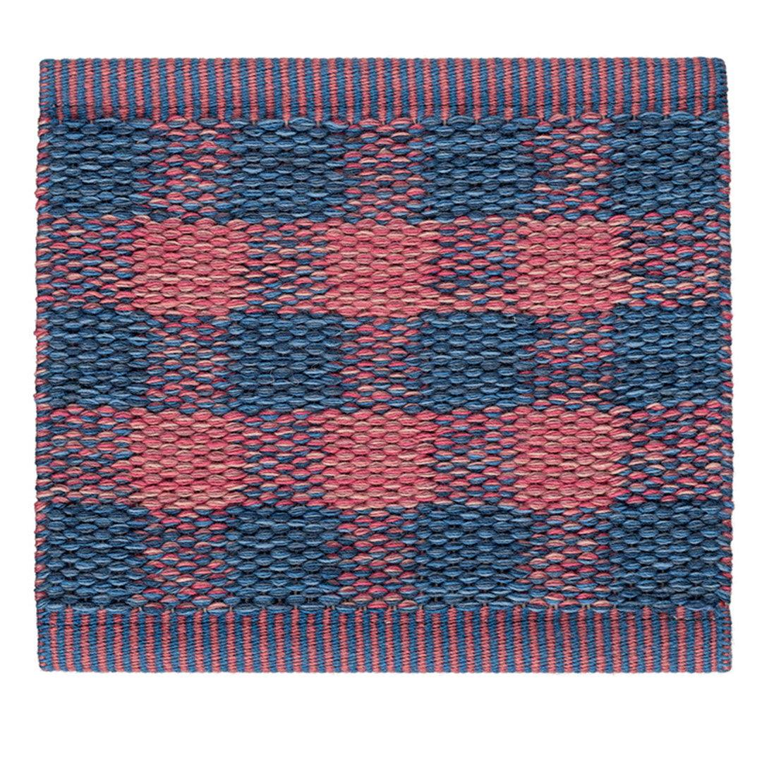 Red and navy checkered pattern with textured weave and contrasting stripes along the edges.