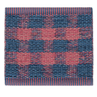 Red and navy checkered pattern with textured weave and contrasting stripes along the edges.