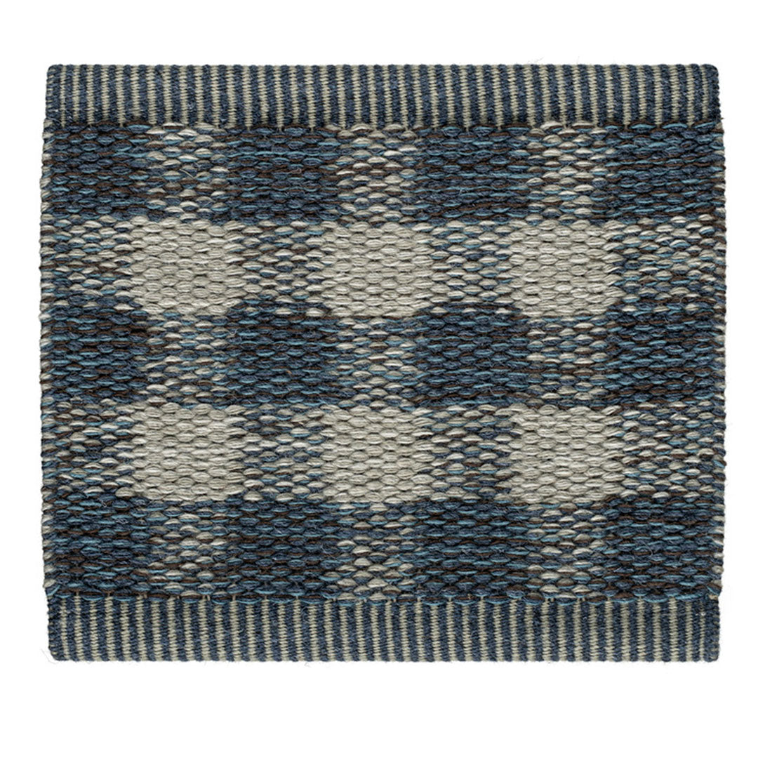 Blue and gray checkered patterned rug with a textured finish and striped border. Perfect for modern decor.