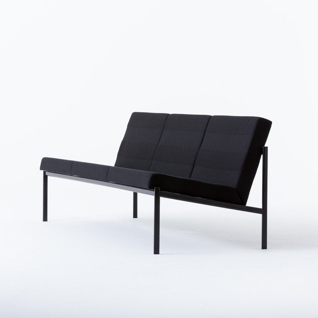 Black minimalist sofa with geometric pattern and sleek metal frame, perfect for modern living spaces.